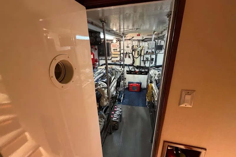  Yacht Photos Pics Engine room of a 1991 Hatteras 70 Motor Yacht, featuring equipment and tools.