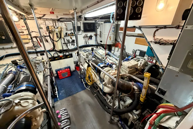  Yacht Photos Pics Engine room of a 1991 Hatteras 70 Motor Yacht, showcasing machinery and tools.