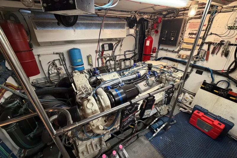  Yacht Photos Pics Engine room of a 1991 Hatteras 70 Motor Yacht, featuring complex machinery and tools.