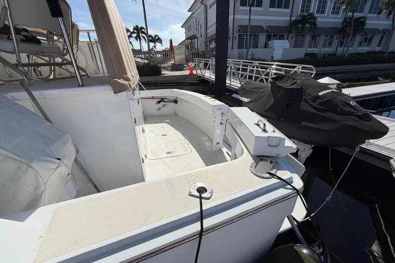  Yacht Photos Pics 1991 Hatteras 70 Motor Yacht docked, featuring spacious deck and covered seating area.