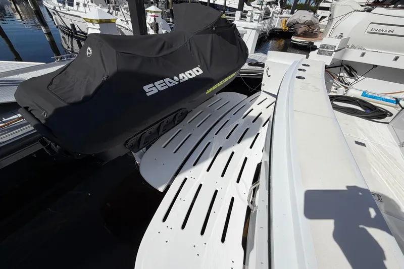  Yacht Photos Pics 1991 Hatteras 70 Motor Yacht with covered Sea-Doo on deck, docked at marina.