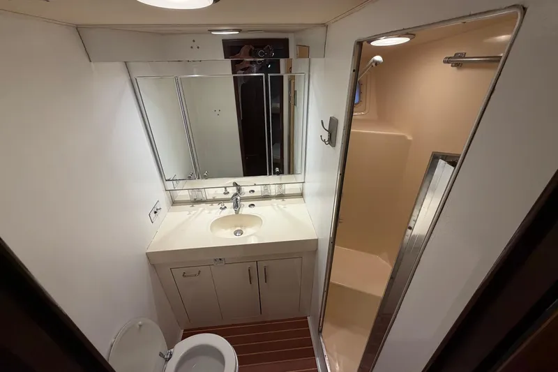  Yacht Photos Pics Bathroom interior of 1991 Hatteras 70 Motor Yacht with sink, mirror, and shower.