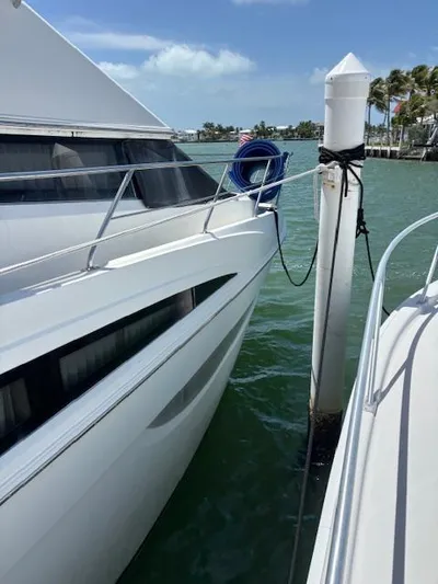 Yacht Photos Pics 2006 Carver 43 Motor Yacht docked, sunny day, calm waters, blue sky.