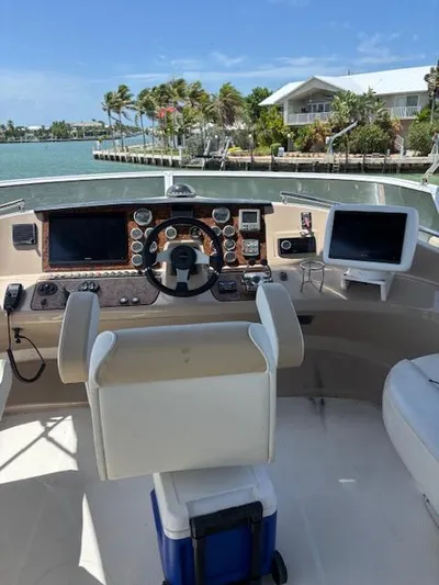  Yacht Photos Pics Helm of 2006 Carver 43 Motor Yacht with navigational equipment, overlooking a scenic waterfront.