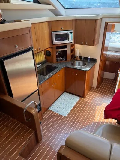  Yacht Photos Pics Interior of 2006 Carver 43 Motor Yacht with kitchen and wood flooring.