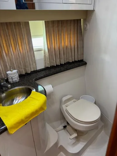  Yacht Photos Pics 2006 Carver 43 Motor Yacht bathroom with sink, toilet, and window with curtains.