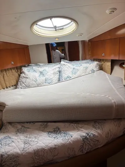  Yacht Photos Pics Interior of 2006 Carver 43 Motor Yacht with cozy bed and porthole window.