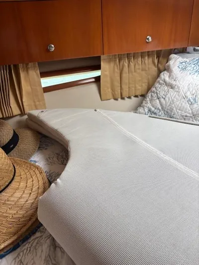  Yacht Photos Pics Interior of 2006 Carver 43 Motor Yacht with bed, pillows, and straw hats.