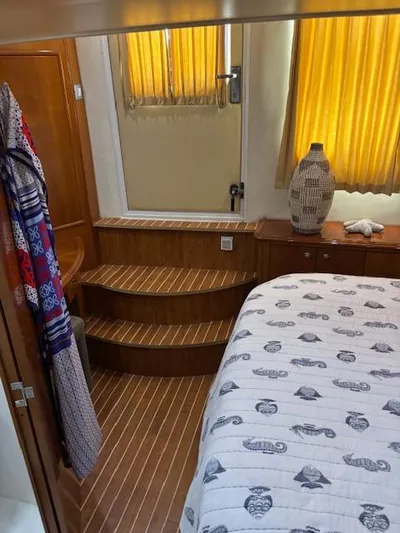  Yacht Photos Pics Interior of 2006 Carver 43 Motor Yacht with wooden steps and nautical-themed bedding.
