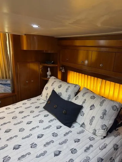  Yacht Photos Pics Luxurious bedroom interior of 2006 Carver 43 Motor Yacht with elegant bedding and warm lighting.