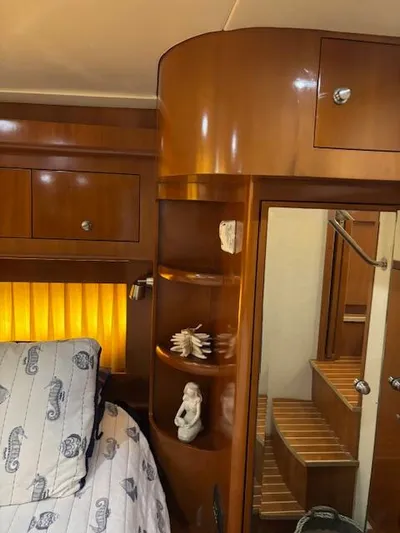  Yacht Photos Pics Luxurious 2006 Carver 43 Motor Yacht interior with wooden cabinetry and cozy bedroom.
