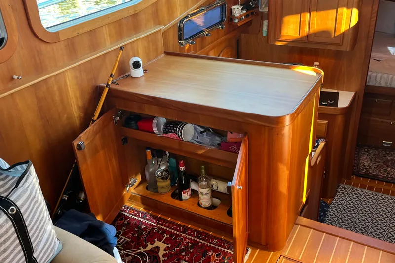 Sachem Yacht Photos Pics Interior of 2006 Sabre 36 Flybridge Sedan with wooden cabinetry and open storage.