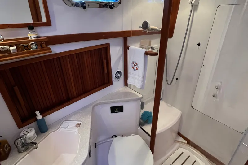 Sachem Yacht Photos Pics Bathroom interior of 2006 Sabre 36 Flybridge Sedan yacht, featuring sink, shower, and wooden accents.