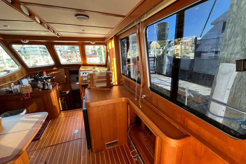 Sachem Yacht Photos Pics Interior of 2006 Sabre 36 Flybridge Sedan with wooden finishes and large windows.