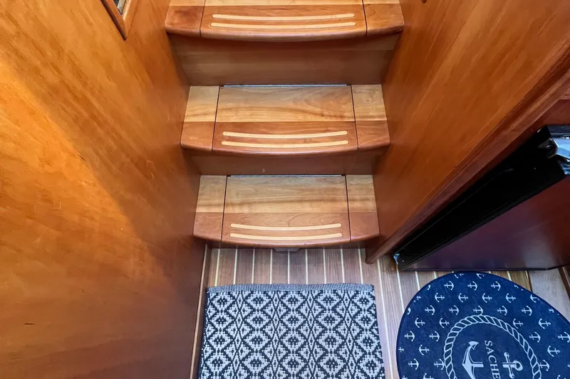 Sachem Yacht Photos Pics Wooden stairs and patterned rug inside 2006 Sabre 36 Flybridge Sedan yacht.