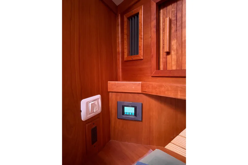 Sachem Yacht Photos Pics Interior of 2006 Sabre 36 Flybridge Sedan with wooden paneling and control panel.