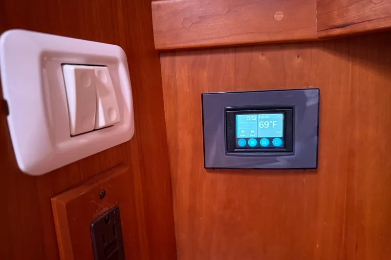 Sachem Yacht Photos Pics Thermostat and light switch on 2006 Sabre 36 Flybridge Sedan yacht interior.