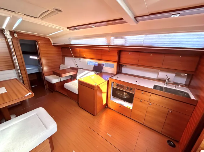 4770jg Yacht Photos Pics Interior of 2015 Dufour 410 GL yacht with modern kitchen and seating area.