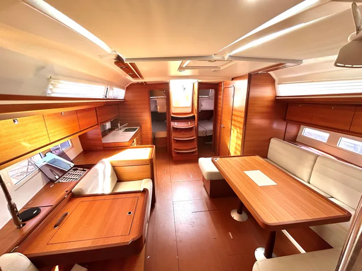 4770jg Yacht Photos Pics Interior of 2015 Dufour 410 GL yacht, featuring wood finish and spacious seating area.