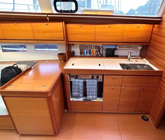 4770jg Yacht Photos Pics Modern kitchen interior of 2015 Dufour 410 GL yacht with wooden cabinetry.