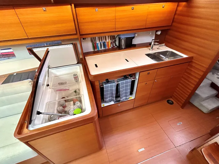 4770jg Yacht Photos Pics Modern kitchen in 2015 Dufour 410 GL yacht with wooden cabinetry and appliances.