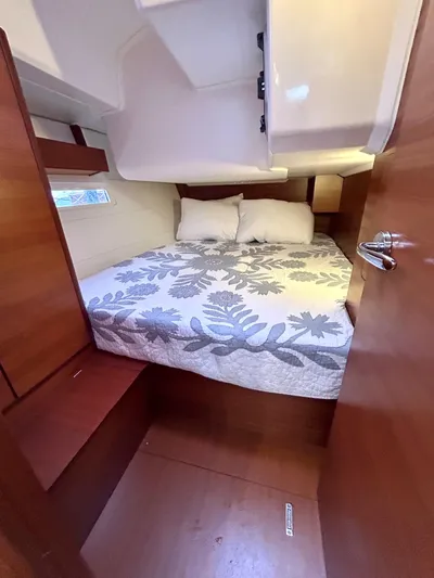 4770jg Yacht Photos Pics Cozy cabin interior of 2015 Dufour 410 GL sailboat with double bed and wooden finish.
