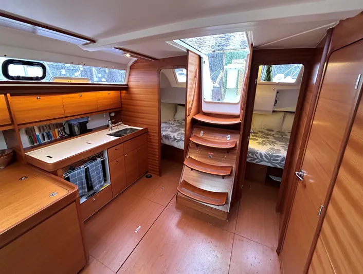 4770jg Yacht Photos Pics Interior of 2015 Dufour 410 GL yacht with wooden cabinetry and cozy sleeping quarters.