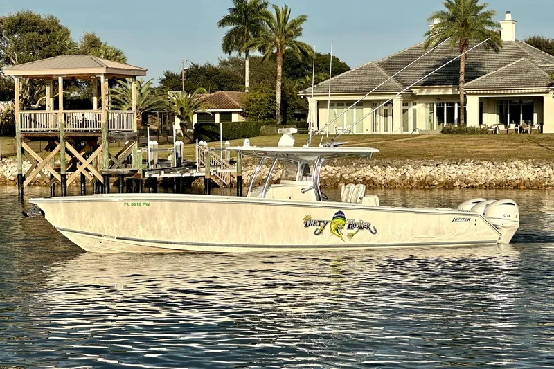  Yacht Photos Pics 2015 Jupiter 38 FS boat on water near a dock and waterfront home.