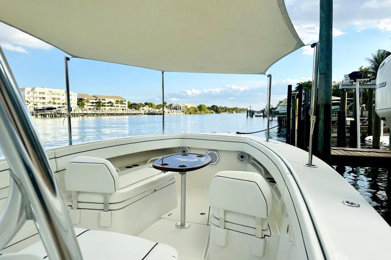  Yacht Photos Pics 2015 Jupiter 38 FS boat with canopy, docked in a scenic waterfront location.
