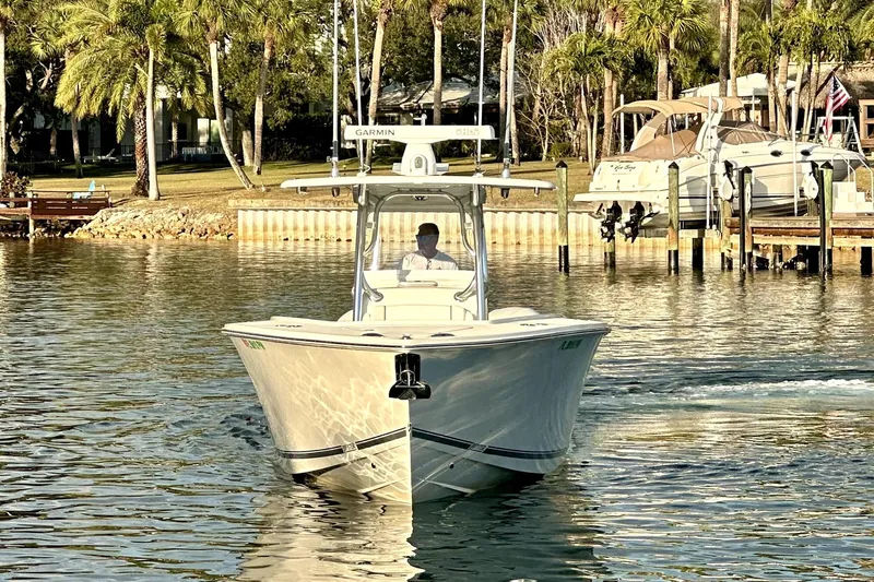  Yacht Photos Pics 2015 Jupiter 38 FS boat cruising on a sunny waterfront with palm trees.