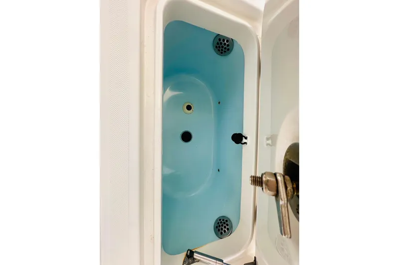  Yacht Photos Pics Livewell compartment of a 2015 Jupiter 38 FS boat, featuring blue interior and drainage system.