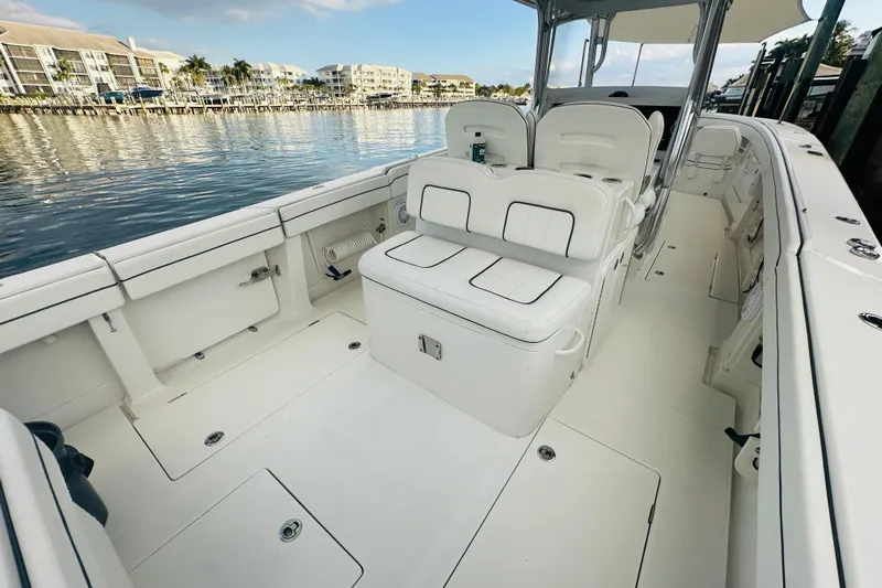 Yacht Photos Pics 2015 Jupiter 38 FS boat interior with white seating, docked by waterfront buildings.