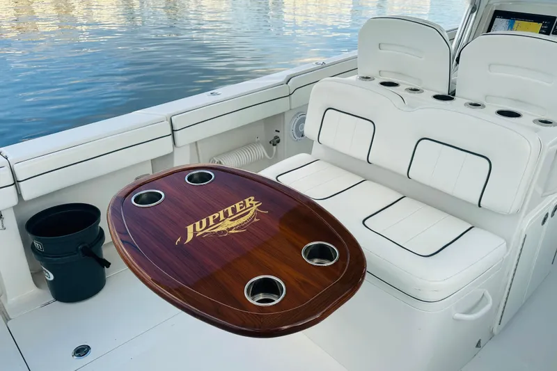  Yacht Photos Pics 2015 Jupiter 38 FS boat interior with white seating and wooden table.