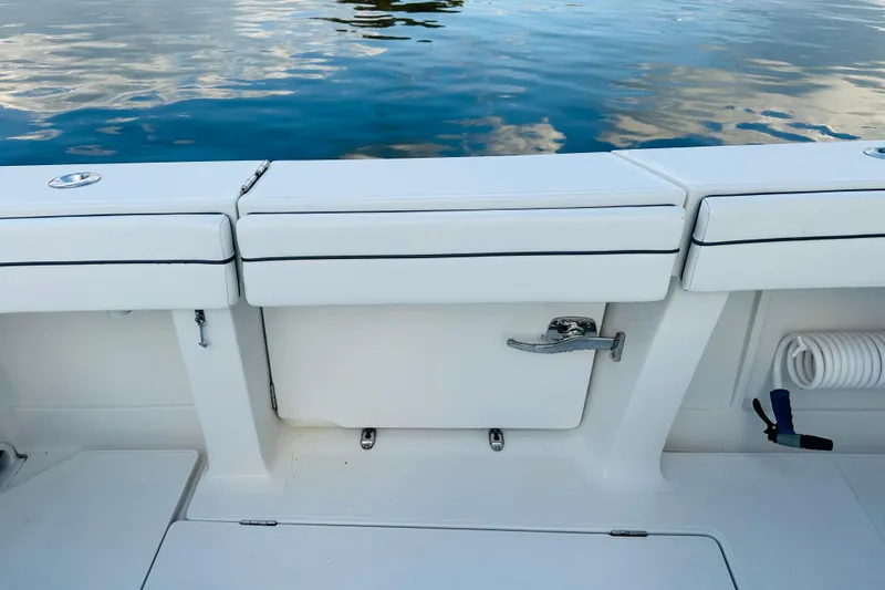  Yacht Photos Pics 2015 Jupiter 38 FS boat deck with storage compartment and water reflection.