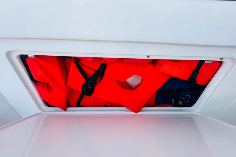  Yacht Photos Pics Storage compartment with red life jackets on a 2015 Jupiter 38 FS boat.