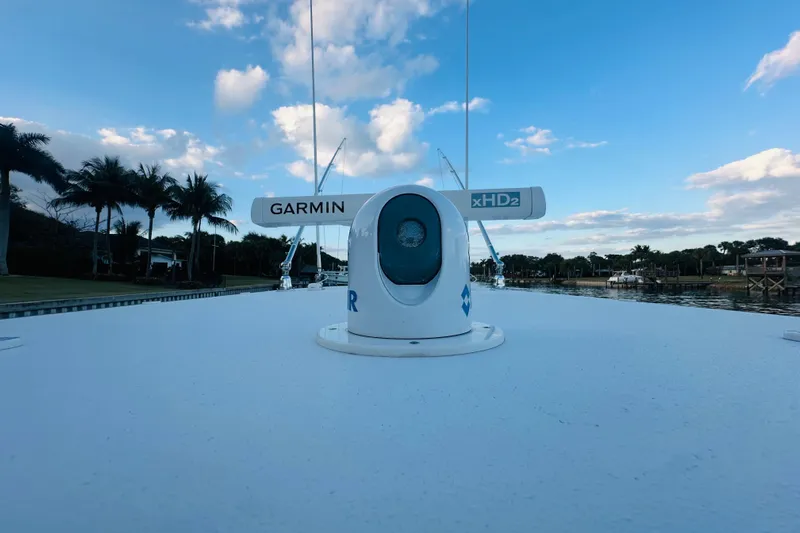  Yacht Photos Pics 2015 Jupiter 38 FS boat with Garmin xHD2 radar, palm trees, and blue sky background.