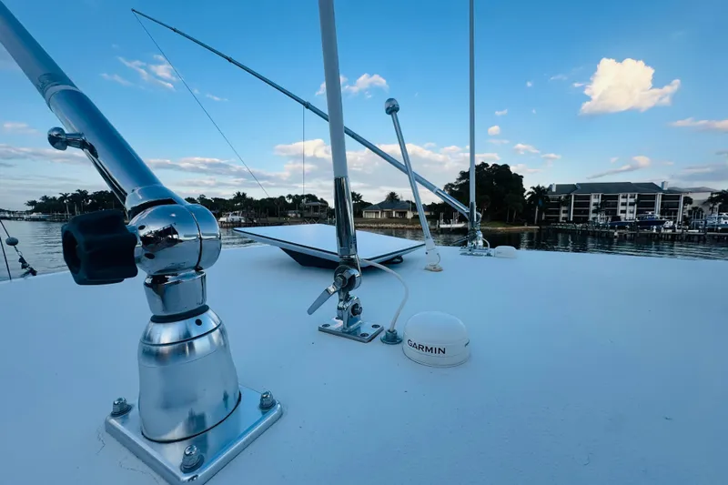  Yacht Photos Pics 2015 Jupiter 38 FS boat deck with fishing rods and Garmin equipment, dockside view.