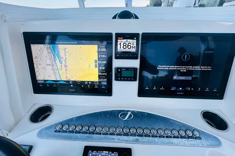  Yacht Photos Pics Control panel of a 2015 Jupiter 38 FS boat with navigation screens.