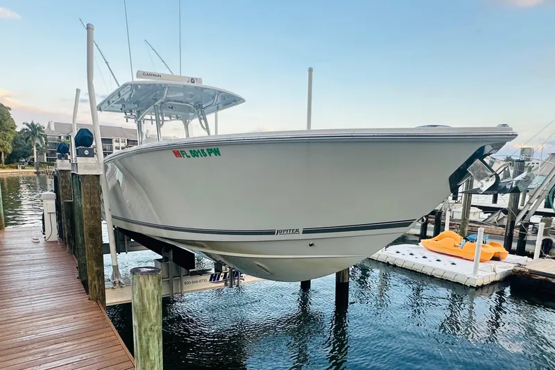  Yacht Photos Pics 2015 Jupiter 38 FS boat docked on a lift by the water.