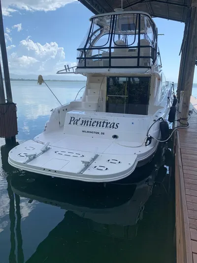  Yacht Photos Pics 2006 Sea Ray 52 Sedan Bridge yacht docked under a canopy.