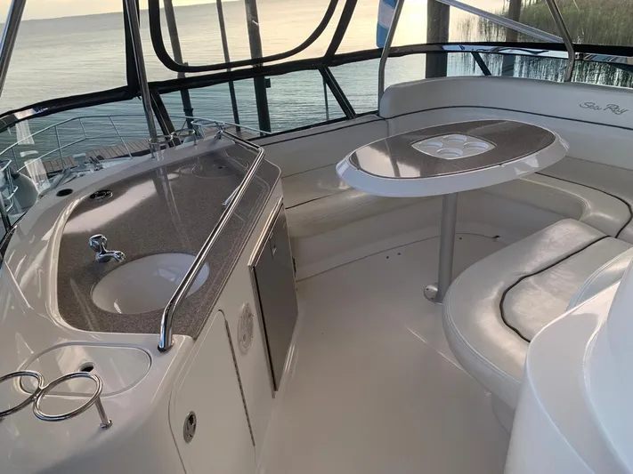  Yacht Photos Pics 2006 Sea Ray 52 Sedan Bridge interior with kitchenette and seating area.