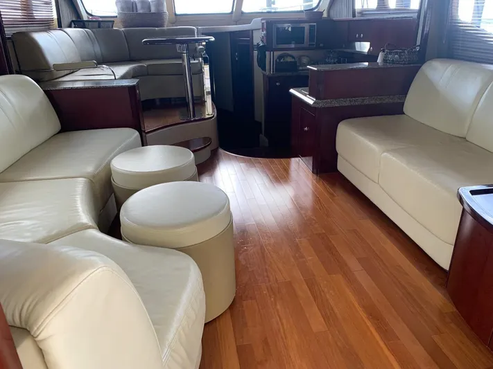  Yacht Photos Pics Luxurious interior of 2006 Sea Ray 52 Sedan Bridge yacht with leather seating and wood flooring.
