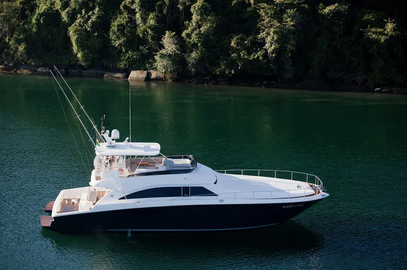 Mare Blu Yacht Photos Pics 2008 Pro Boat Yachts Power Cat 80 on serene water, surrounded by lush greenery.