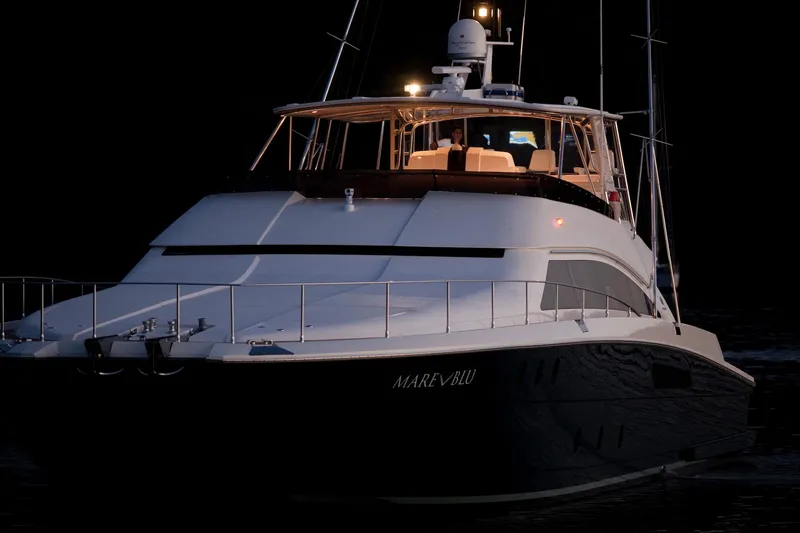 Mare Blu Yacht Photos Pics 2008 Pro Boat Yachts Power Cat 80 illuminated at night on the water.