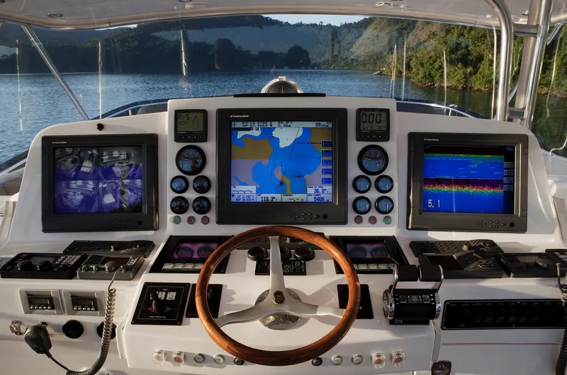 Mare Blu Yacht Photos Pics Control panel of 2008 Pro Boat Yachts Power Cat 80 with navigation screens and steering wheel.