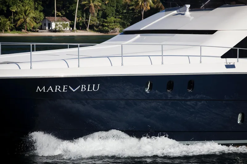 Mare Blu Yacht Photos Pics 2008 Pro Boat Yachts Power Cat 80, "Mare Blu," cruising near a tropical shoreline.