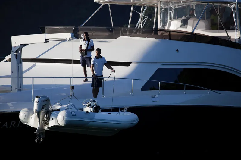 Mare Blu Yacht Photos Pics 2008 Pro Boat Yachts Power Cat 80 with crew and dinghy on deck.