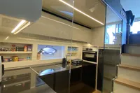 Modern kitchen interior on a 2015 Pershing 70 yacht, featuring sleek design and stainless steel appliances.