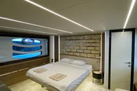 Luxurious bedroom interior of 2015 Pershing 70 yacht with modern design and ambient lighting.