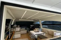 Luxurious interior of a 2015 Pershing 70 yacht with modern seating and elegant decor.